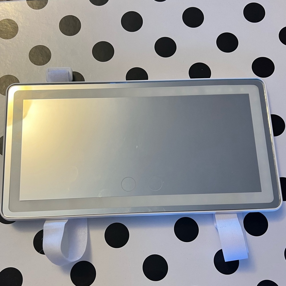 Mirror to hang on your car window shade that lights up. Has a charger port.